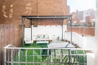 a patio with a table and chairs on a rooftop at Casa Cosi - Putxet 1 in Barcelona