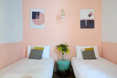two beds sitting next to each other in a room at Casa Cosi - Putxet 2 in Barcelona