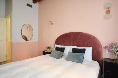 a bedroom with a large white bed with two pillows at Casa Cosi - Putxet 2 in Barcelona