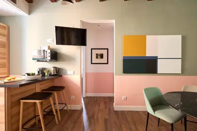 a kitchen with a table and chairs in a room at Casa Cosi - Putxet 2 in Barcelona