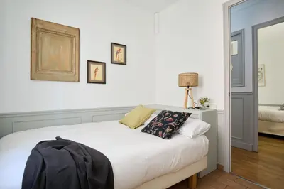 a bedroom with a large white bed and a mirror at Casa Cosi - Sant Gervasi 2 in Barcelona