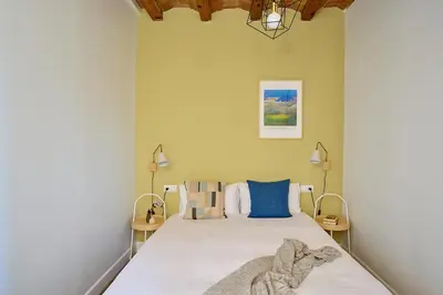 a bedroom with a large bed with two lamps at Casa Cosi - Sant Gervasi 4 in Barcelona