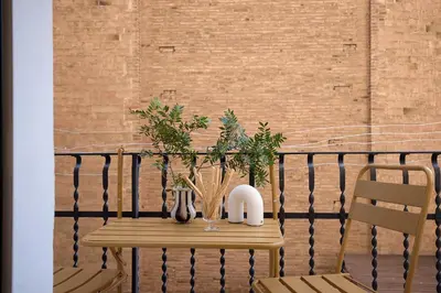 a wooden table with plants on a balcony at Casa Cosi - Sant Gervasi 4 in Barcelona