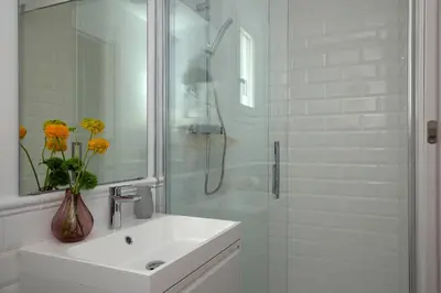 a white bathroom with a sink and a shower at Casa Cosi - Sant Gervasi 4 in Barcelona