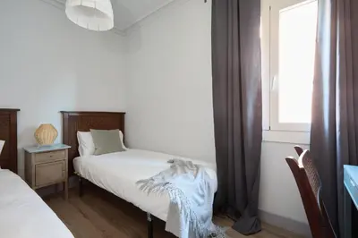 a bedroom with two beds and a window at Casa Cosi - El Farro 2 in Barcelona