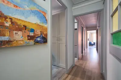 a hallway with a painting on the wall at Casa Cosi - El Farro 2 in Barcelona