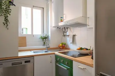 a small kitchen with a sink and a window at Casa Cosi - El Farro 2 in Barcelona