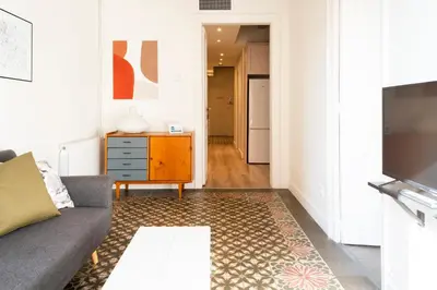 a living room with a couch and a table at Casa Cosi - La Gleva 4 in Barcelona