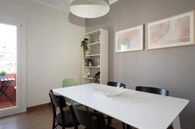 a dining room with a white table and chairs at Casa Cosi - Casanova 7 in Barcelona
