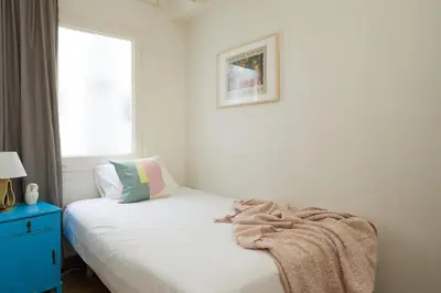 a bedroom with a bed with a blanket on it at Casa Cosi - Casanova 7 in Barcelona