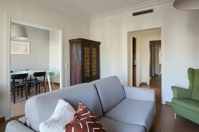 a living room with a couch and a dining room at Casa Cosi - Casanova 7 in Barcelona