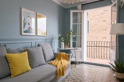 a living room with a couch and a window at Casa Cosi - El Farro 1 in Barcelona