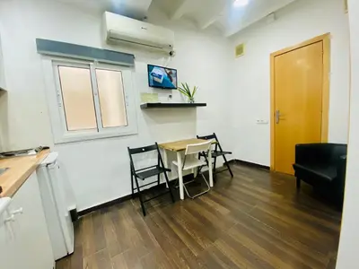 a kitchen and dining room with a table and chairs at 09 Apartament born 4 2 in Barcelona