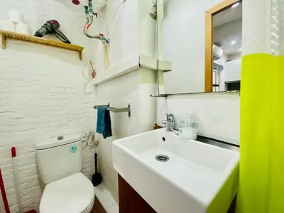 a bathroom with a white toilet and a sink at 09 Apartament born 4 2 in Barcelona