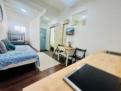 a bedroom with a bed and a desk with a table at 09 Apartament born 4 2 in Barcelona