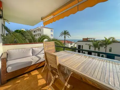 a balcony with a couch and a table at Balmins Surf by Hello Homes Sitges in Sitges