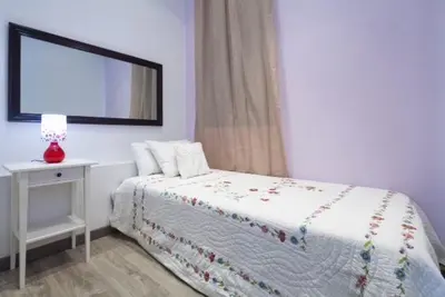 a bedroom with a bed and a table with a mirror at Paseo de Gracia Apartments in Barcelona