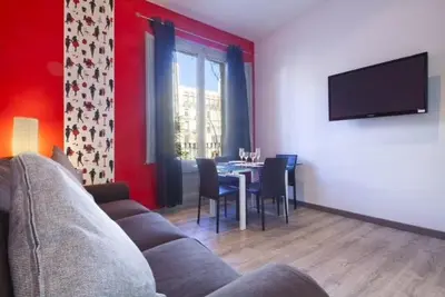 a living room with a couch and a table with chairs at Paseo de Gracia Apartments in Barcelona