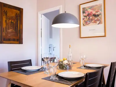 a dining room table with a black pendant light at Clot market in Barcelona