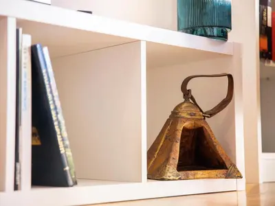 a bell on a shelf with books at Clot market in Barcelona