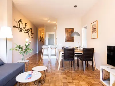 a living room with a couch and a table and chairs at Clot market in Barcelona