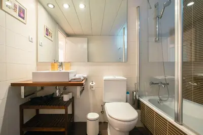a bathroom with a toilet and a sink and a shower at Sardenya Apartment by Olala Homes in Barcelona