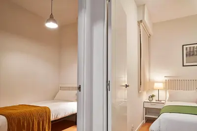 a small room with two beds and a closet at Love Local Life Near Sagrada Familia by MyRentalHost in Barcelona