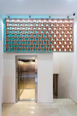 a elevator in a building with a blue and white wall at 8 lacus in Hospitalet de Llobregat