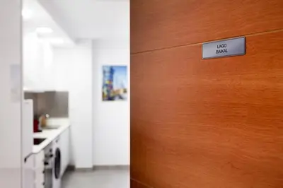 a wooden door with a sign that reads lost exit at 8 lacus BAIKAL in Hospitalet de Llobregat