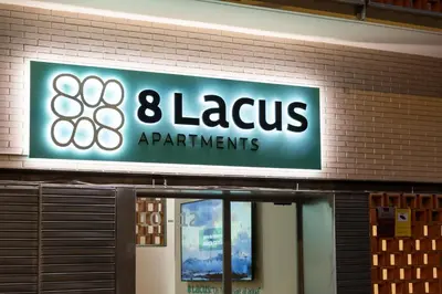 a sign on a building that says lazarus apartments at 8 lacus BAIKAL in Hospitalet de Llobregat