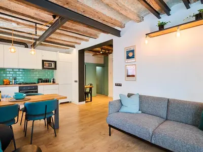 a living room with a couch and a table at Casa Wilson by MyRentalHost in Barcelona