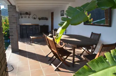 a dining room with a table and chairs on a patio at Sea view, Wonderful pool, Nature, Peaceful & AC in Sant Cebrià de Vallalta
