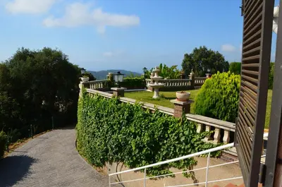 a garden with a fence and a bench at Sea view, Wonderful pool, Nature, Peaceful & AC in Sant Cebrià de Vallalta