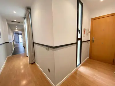 an empty room with a door and a hallway at Liceu Apartments by gaiarooms in Barcelona