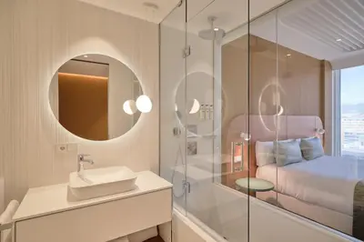 a bathroom with a shower and a sink and a mirror at Hotel Marina Badalona in Badalona