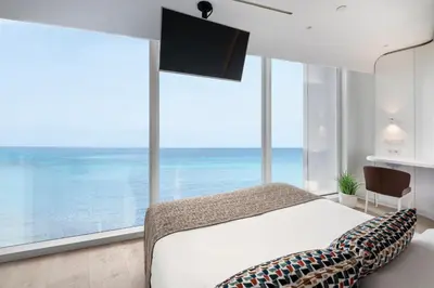a bedroom with a bed and a large window at Hotel Marina Badalona in Badalona