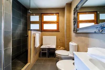 a bathroom with a toilet and a sink and a mirror at Villa Marco in Canyelles