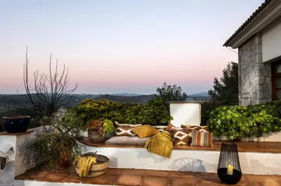 a couch sitting on a patio with pillows at Villa Marco in Canyelles