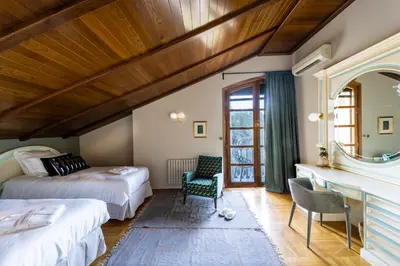 a bedroom with two beds and a mirror at Villa Marco in Canyelles