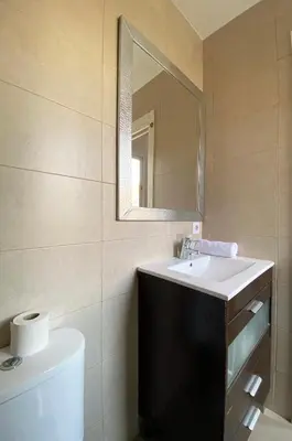a bathroom with a white sink and a mirror at Stay U-nique Apartments Sagrada Familia III in Barcelona