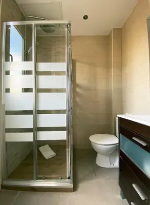 a bathroom with a shower and a toilet at Stay U-nique Apartments Sagrada Familia III in Barcelona