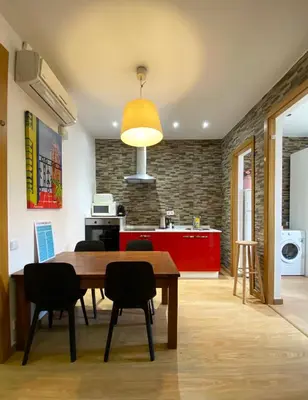 a kitchen and dining room with a wooden table and chairs at Stay U-nique Apartments Sagrada Familia III in Barcelona