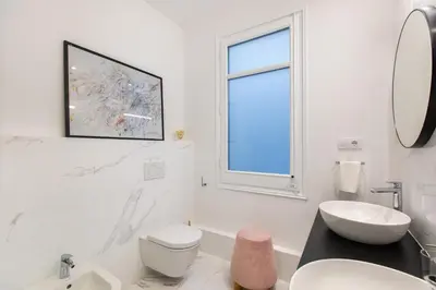 a white bathroom with a sink and a toilet at Majestic 4BR/4BATH apartment in Sagrada Familia area in Barcelona