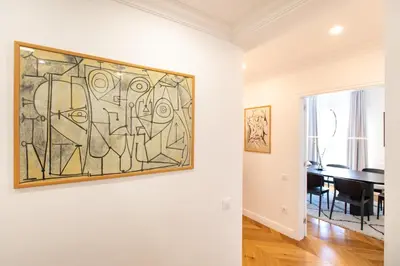 a painting on a wall in a room with a table at Majestic 4BR/4BATH apartment in Sagrada Familia area in Barcelona