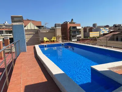 a swimming pool on the roof of a building at Piscina en Centro de Terrassa in Terrassa
