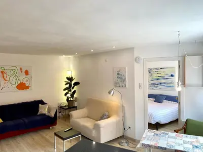a living room with a couch and a bed at Piscina en Centro de Terrassa in Terrassa