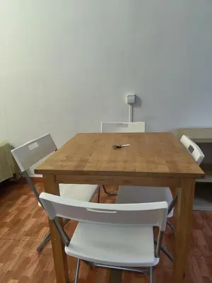 a wooden table with white chairs in a room at 06 DUPlEX LOFT in Barcelona