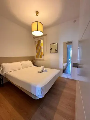 a bedroom with a large bed and a light at Plaza Spain Barcelona Apartments in Barcelona