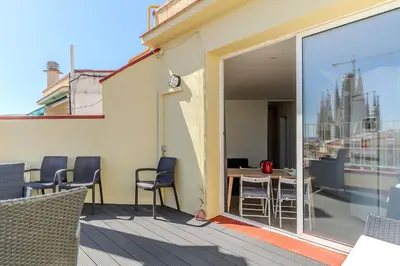 a balcony with chairs and a table on a building at 1521 - AB Sagrada Família Comfort in Barcelona