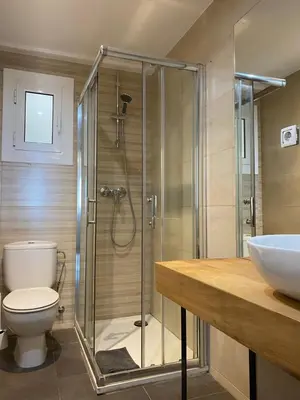 a bathroom with a shower and a toilet and a sink at Amazing sea and Sagrada Familia views homey apartment in Barcelona